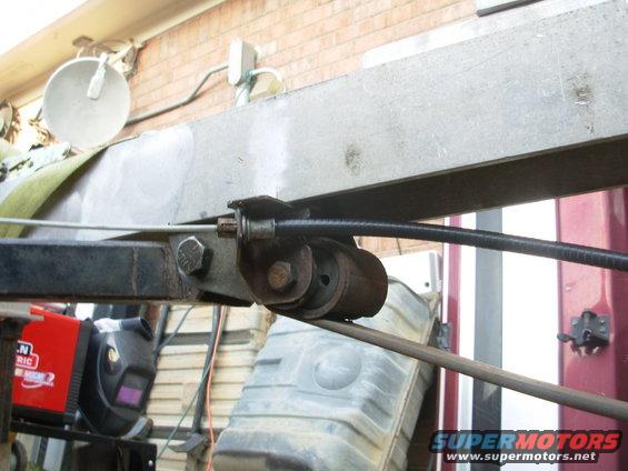 45cabler.jpg There's a tab behind the spring backet that prevents it from rotating on the single bolt.