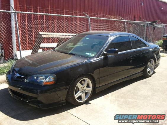 Black Acura CL coupe parked on concrete, front 3/4 view