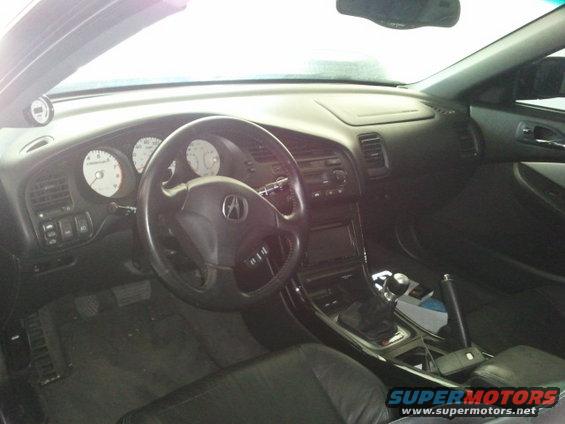 Car interior with Acura logo on steering wheel and white-faced gauges