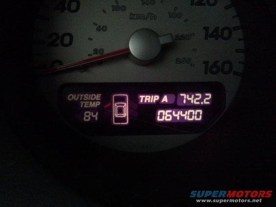 Car dashboard showing 84 degrees Fahrenheit outside temperature and 64,400 miles on the odometer