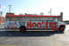 1990 Ford Bronco - A bus with "Follow Me To Hooters" advertisement is parked on asphalt.