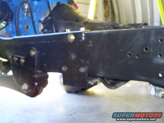Close-up of vehicle frame and suspension parts, possibly from a truck or SUV