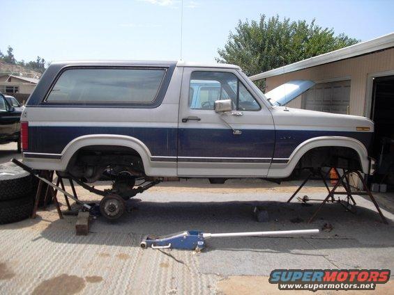 1986 Ford Bronco lifted on jack stands with front and rear axles removed
