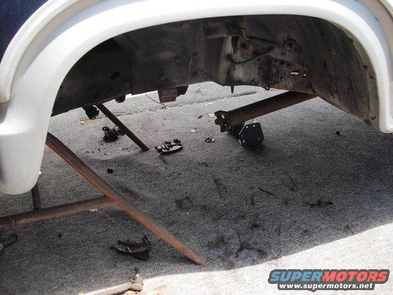 Undercarriage of a vehicle with parts removed, possibly a drive shaft