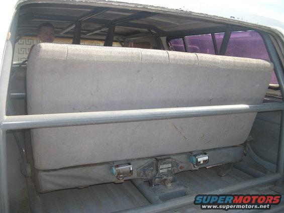 Interior view of vehicle with roll cage and rear seat