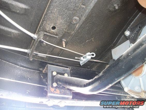 Underside view of parking brake cables and linkage