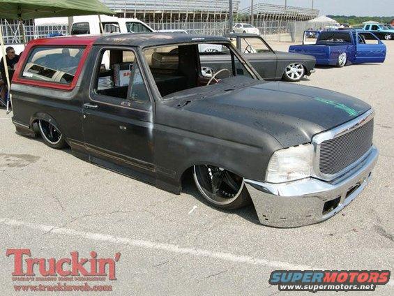 Black and red lowered SUV with chrome grille and bumper