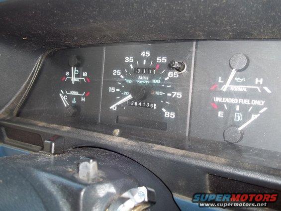 Dashboard gauges showing speedometer, fuel, and temperature, with odometer reading 294136