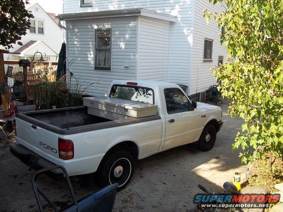 White Ford Ranger pickup truck parked in driveway with toolbox in bed