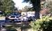 1979 Ford Bronco - Two Ford Broncos, one a 1979 model, are parked on a street in front of houses.