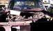 1979 Ford Bronco - The engine compartment of a red pickup truck is shown with various mechanical components exposed.