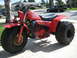 1982 Honda 250 R - This red 1982 Honda 250 R three-wheeler is shown in a 3q-front view, parked on a driveway.