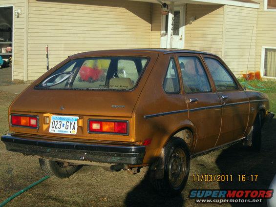 Brown hatchback car parked in front of a house. License plate reads 023-GYA