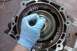 2005 GMC Yukon - Mechanic works on internal transmission component, likely during a rebuild.