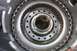 2005 GMC Yukon - Close-up of a transmission clutch pack, showing intricate metal components and a central bearing.
