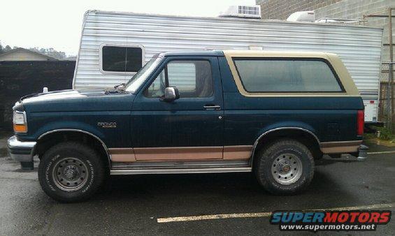Side view of a 1994 Ford Bronco with tan trim and a removable top