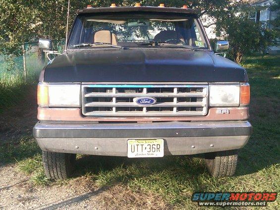 Front view of a 1988 Ford F-350 truck with a brown grille and black hood