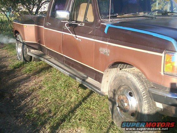 1988 Ford F-350 dually truck side view, brown and tan two-tone paint, dual rear wheels, exhaust smoke