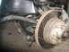 1992 GMC Safari - Front suspension and brake assembly detail, showing rotor, caliper, and tie rod end.