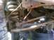 1989 Ford Bronco - Undercarriage view of rusty suspension components and a spare tire.