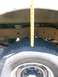 1989 Ford Bronco - Measuring the distance between the tire and the wheel well to assess suspension height.