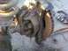 1989 Ford Bronco - Close-up of a heavily rusted vehicle axle assembly, including brake components.