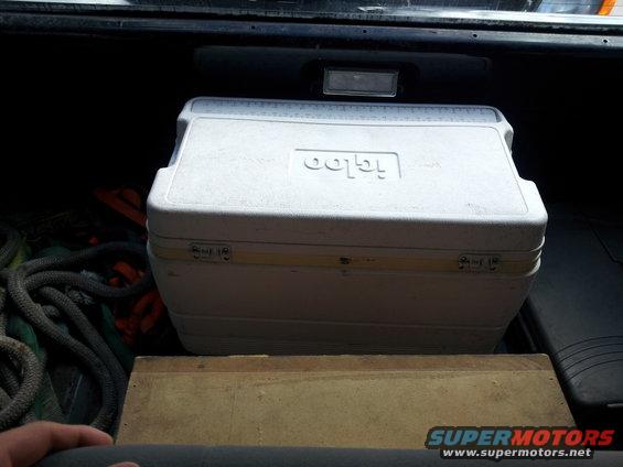Igloo cooler and ropes in the back of a vehicle