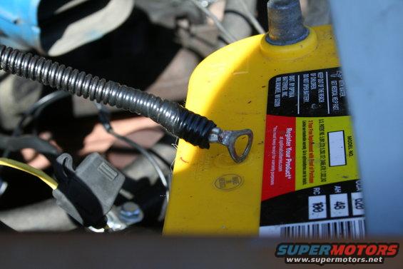 Yellow Optima battery with wiring and a metal loop connector
