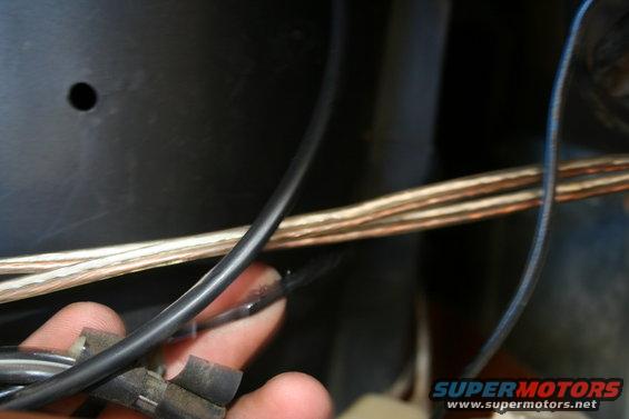 Close-up of a hand holding electrical wires and connectors
