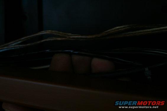Close-up of fingers reaching into a bundle of wires