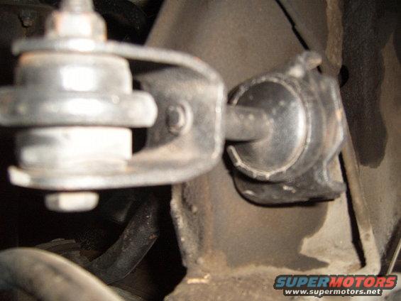 Close-up of a vehicle suspension component, possibly a sway bar link