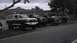 1989 Ford Bronco - Several Ford trucks and a 1989 Ford Bronco are parked in a row outside a building.