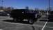 1989 Ford Bronco - A black Ford Bronco is parked in a lot on a sunny day.
