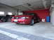 2003 Mercury Marauder - A red Ford Mustang is parked in a garage with bicycles and other items in the background.