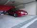 2003 Mercury Marauder - Red Ford Mustang coupe parked in a garage, showing its front 3/4 view with a visible license plate.