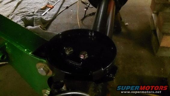 Black suspension part with bolts, green frame component