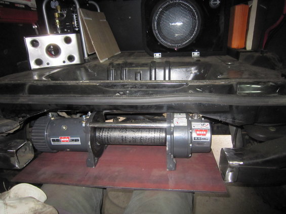 Warn XP winch mounted below a vehicle's bumper, with a speaker and control box visible above