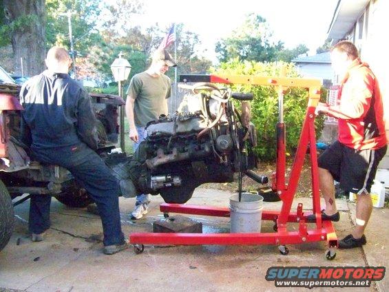 Engine being lifted out of a vehicle with an engine hoist
