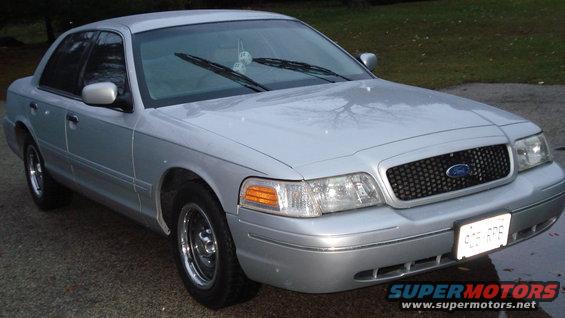 Silver 2000 Ford Crown Victoria parked outside, front quarter view