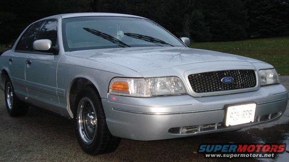 Silver 2000 Ford Crown Victoria parked outside