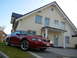 2003 Mercury Marauder - Red coupe with a hood scoop parked on a driveway in front of a house.