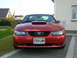 2003 Mercury Marauder - This red Ford Mustang features a prominent hood scoop and the iconic pony emblem on its grille.