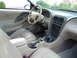 2003 Mercury Marauder - Interior view of a tan car, showing the dashboard, steering wheel, and seats.