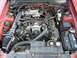 2003 Mercury Marauder - Engine bay of a red Ford Mustang, aftermarket K&N air intake and other components.
