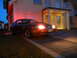 2003 Mercury Marauder - Red coupe parked in front of a house at dusk, headlights illuminated.