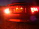 2003 Mercury Marauder - Rear view of a red Ford Mustang GT at night, showing its taillights and license plate.