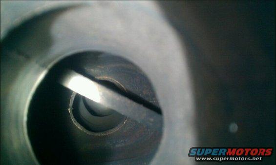 Close-up view inside an engine cylinder showing a valve