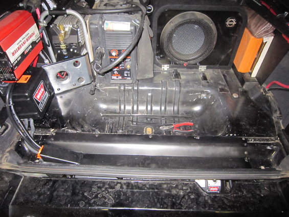 Interior of a vehicle showing a Warn winch, a power inverter, a speaker, and other electronic equipment installed