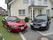 2003 Mercury Marauder - Two cars, a red Ford Mustang and a black Audi A6 wagon, are parked in front of a house.