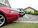 2003 Mercury Marauder - A red Ford Mustang is parked next to a black Audi A6, which displays a 2006 license plate.